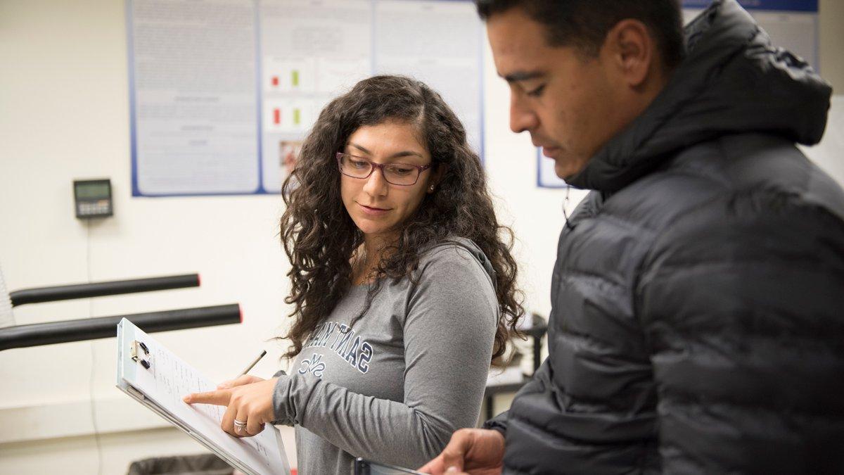 Students in a kinesiology class looking at clip boards